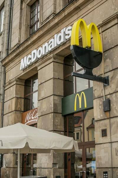 Free Street view of a McDonald's facade in Wrocław, Poland showcasing the iconic golden arches. Stock Photo