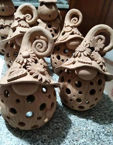 several clay vases sitting on top of a marble counter covered in carvings and designs