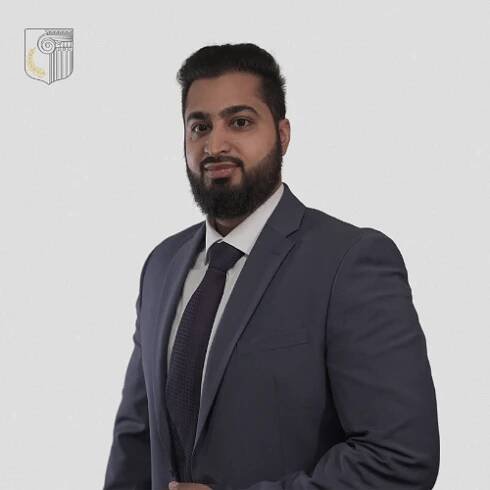 A man with a beard is wearing a suit and tie
