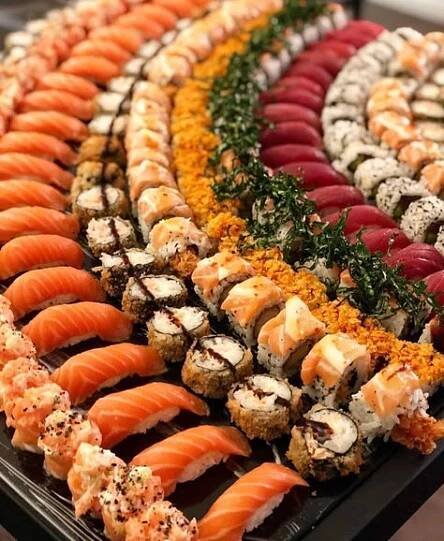 an assortment of sushi on display in a buffet