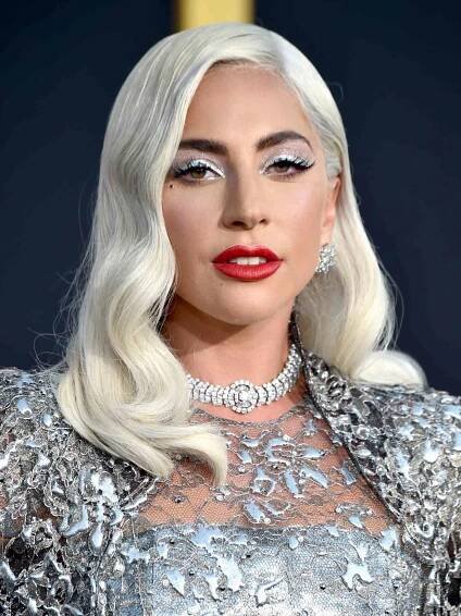 Lady Gaga with silver glitter eye makeup and a red lip - InStyle Wedding Guest Makeup