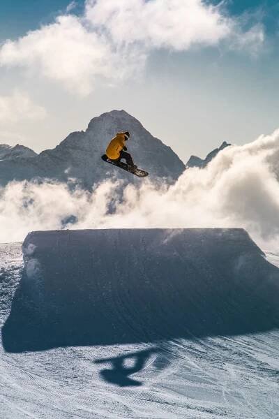 The image shows somebody snowboarding.