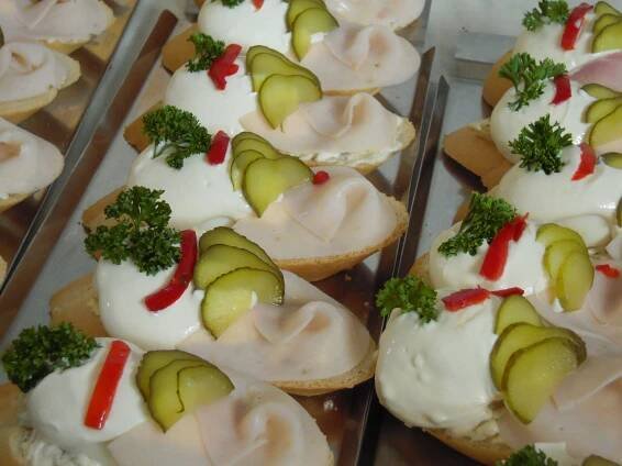 several trays filled with assorted appetizers on top of metal pans