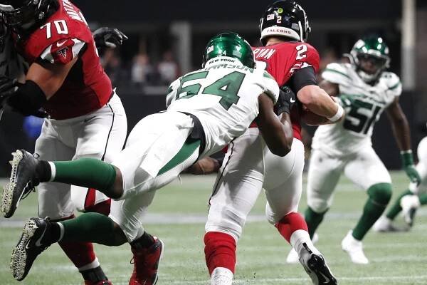 Avery Williamson sacks Matt Ryan in the first quarter of the Jets' 22-10 win over the Falcons on Thursday night. A quarter later he suffered a season-ending knee injury.