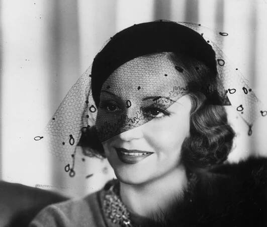 Tallulah Bankhead wearing black hat and a veil 