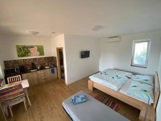 a bedroom with a bed and a table in it at Apartmány Přítluky in Přítluky