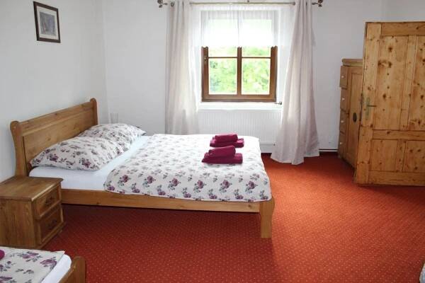 a bedroom with a bed and a window at Penzion Krcma in Dolní Morava