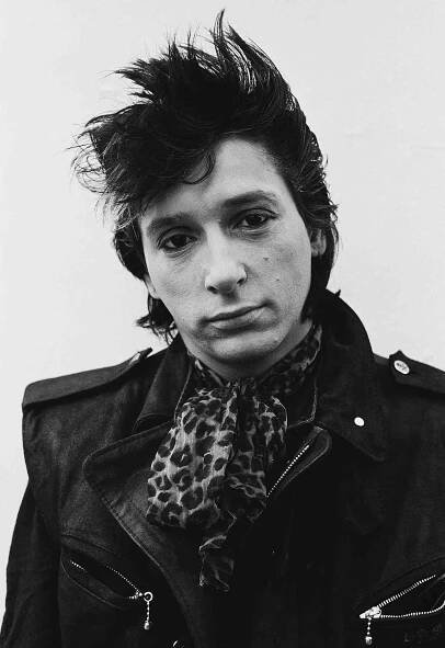 Johnny Thunders wears a leopard-print ascot while posing for a portrait in Notting Hill, London, in 1980