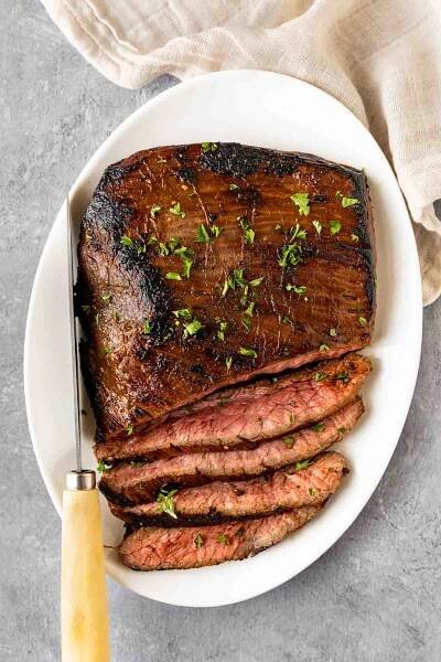 Marinated Flank Steak is the perfect way to make a tender, juicy steak with no grill needed. Prepped with soy sauce, lemon, and brown sugar.