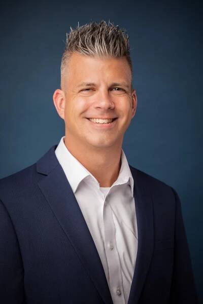 man with spiky gray hair in suit 