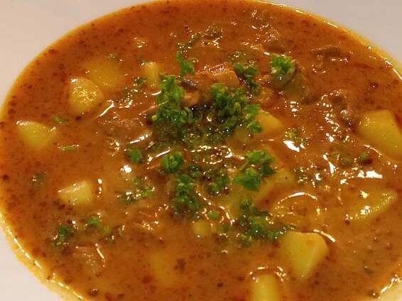 a close up of a bowl of soup on a table