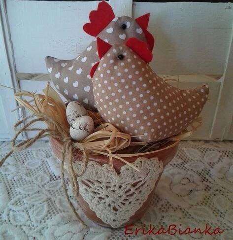 two stuffed chickens sitting on top of a potted planter with eggs in it