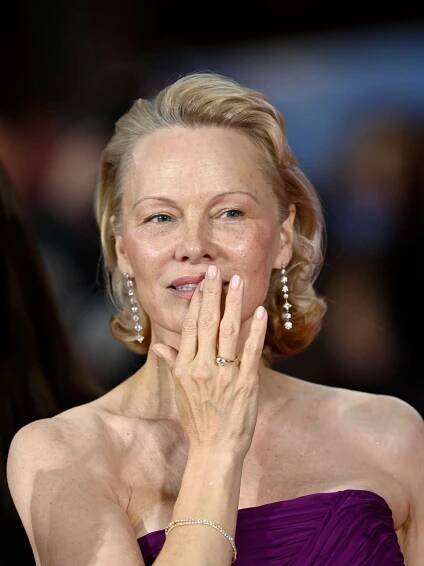 Pamela Anderson shows off her pearly pink manicure.
