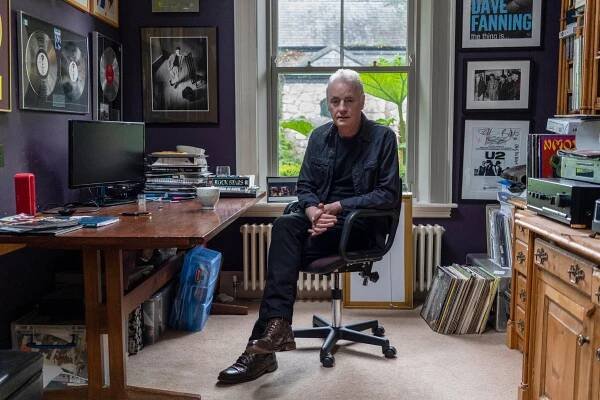 Dave Fanning sitting in a chair by a desk.