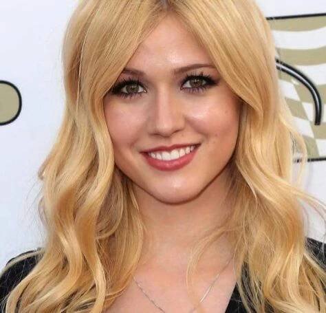 a woman with long blonde hair wearing a black dress