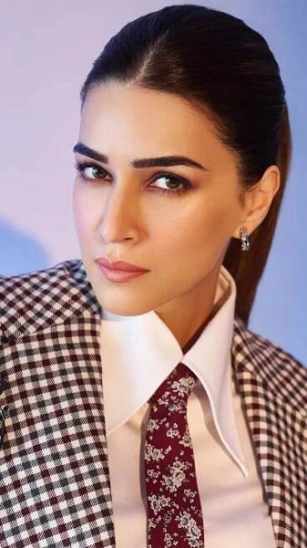 Kriti Sanon aces power dressing ina black gingham three-piece suit with a burgundy tie