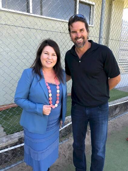 Tennis legend Patrick Rafter signing autograph for a fan. Wallpaper
