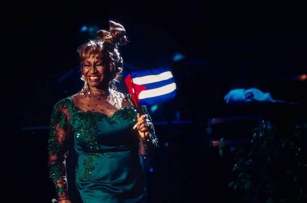 Celia Cruz holds a Cuban flag as she performs during the 'Combinacion Perfecta' concert at Madison Square Garden on Oct. 23, 1993 in New York City.