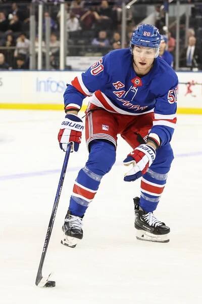 New York Rangers player Will Cuylle (50) skates with the puck.