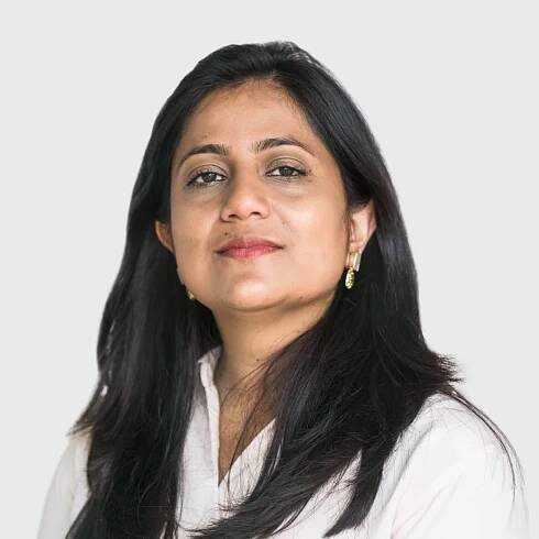 Photo of Sneha Bakshi, Chief People Officer of Genomics Ltd, wearing a light shirt and looking confidently at the camera.