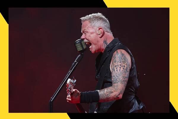 Metallica frontman James Hetfield wails into a microphone with his guitar in hand.