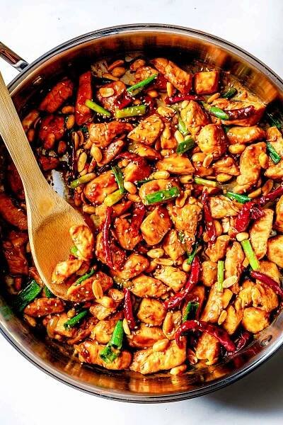 Kung Pao Chicken in skillet with spoon