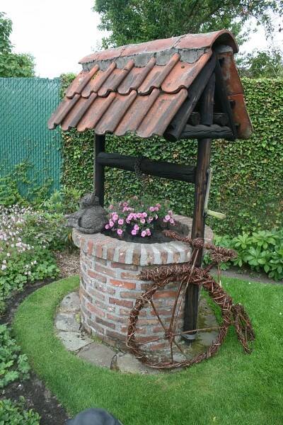 a small brick structure with flowers growing out of it