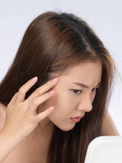 Closeup portrait of young gorgeous asian woman looking in the mirror worry about pimple on her face. Beauty care for skin problem , acne concept. Mirror worry stock images, royalty-free photos and pictures
