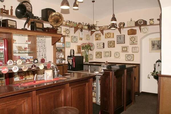 a kitchen with wooden cabinets and plates on the wall at Penzion Aladdin in Teplice
