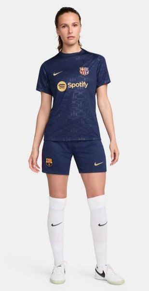 FC Barcelona warm-up shirt featuring a black base with a striking vertical stripe pattern in alternating red and blue. The shirt displays the red Spotify logo in the center, along with the Nike swoosh and FC Barcelona crest, also in red.