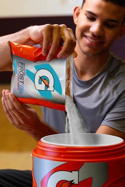 Gatorade Thirst Quencher 6 gallon bag of Glacier Freeze powder being poured into cooler.