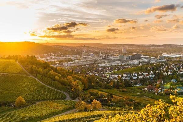 německo, panoramatický výhled na město stuttgart nad vinicemi, průmyslem, domy, ulicemi, stadionem a dálnicí při západu slunce v teplém oranžovém světle - stuttgart - stock snímky, obrázky a fotky