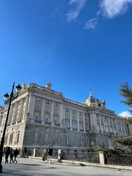 royal palace of madrid with blue skies above.