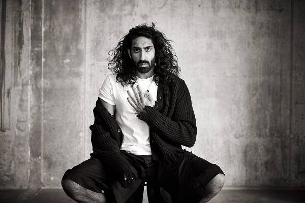 Amar wears ribbed wool cardigan by CONNOLLY. T shirt by ALL SAINTS. Shorts by CRAIG GREEN.