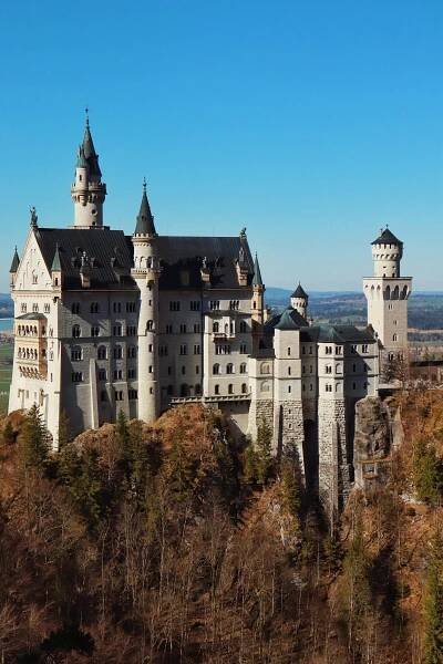 Free Stunning view of Neuschwanstein Castle amidst a clear blue sky in Bavaria. Stock Photo