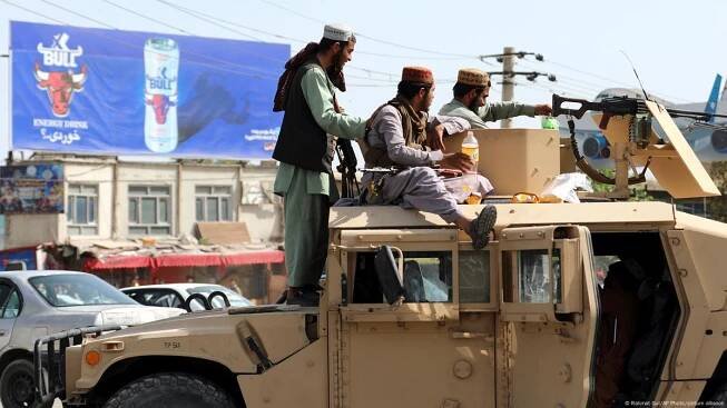 Taliban fighters stand guard in front of the Hamid Karzai International Airport, in Kabul, Afghanistan