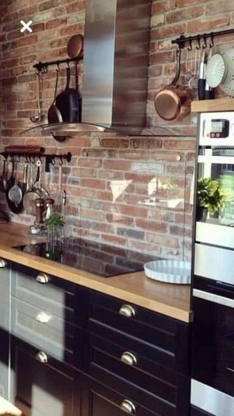 Industrial Kitchen with Brick Wall and Hanging Pots