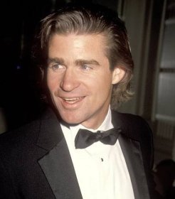 Treat Williams, a man with shoulder-length hair, wearing a tuxedo.