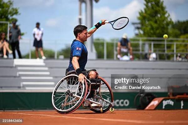 Gordon Reid of Great Britain in action against Nicolas Charrier of France during the Men's Wheelchair Singles First Round match on Day Ten of the...