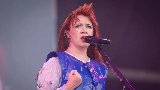 CMAT, dressed in a bright and shiny blue top, sings during day three of Glastonbury festival 2025 at Worthy Farm in Pilton, Somerset. 
