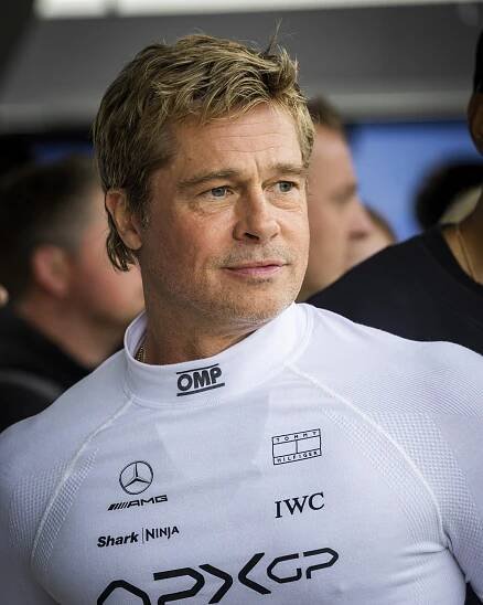 a man wearing a white shirt that says omp and iwc