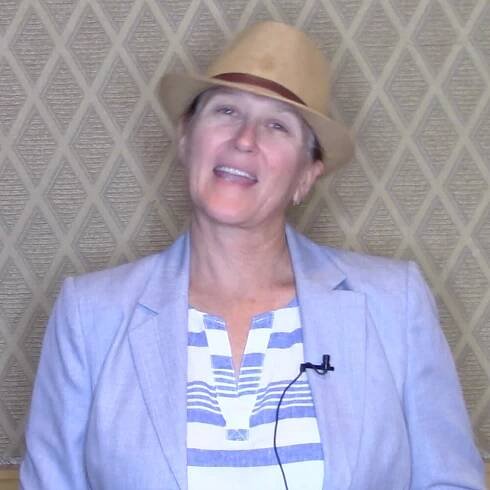 Interior Designer Sarah Beck in a testimonial video thumbnail, praising Coach Dan Gordon for explosive business growth, clickable to play.