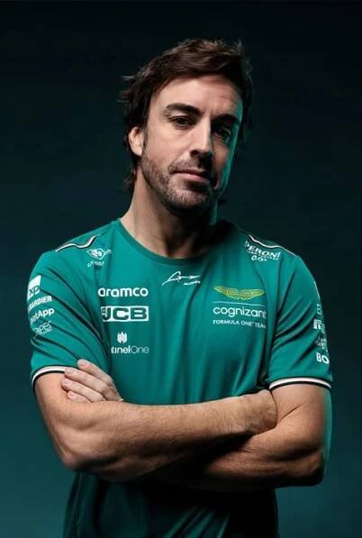 a man with his arms crossed wearing a green shirt