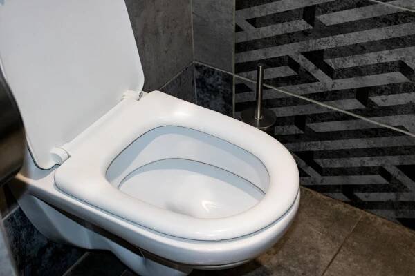 White toilet gray tiles close up