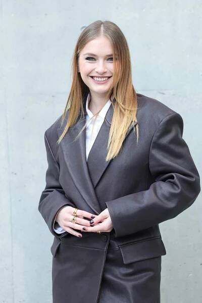 Camille Razat smiling outside in a blazer