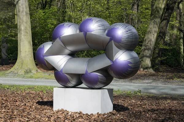 An image containing a sculpture by Richard Deacon of painted and lacquered stainless steel