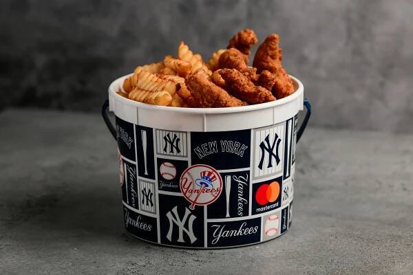 A bucket with chicken and fries.