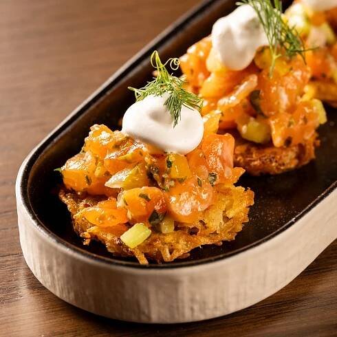 salmon tartare on a latke topped with creme fraiche
