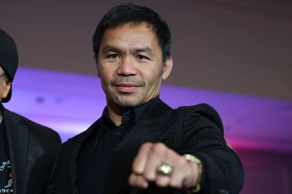 Manny Pacquiao showing off his ring at the International Boxing Hall of Fame.