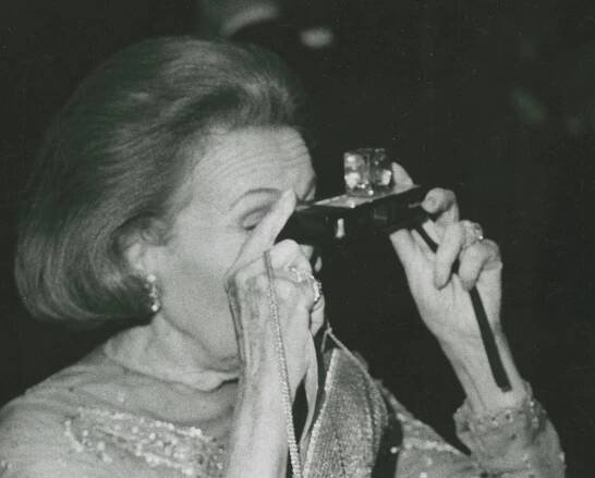 Adele Astaire taking a photo with camera - 1972